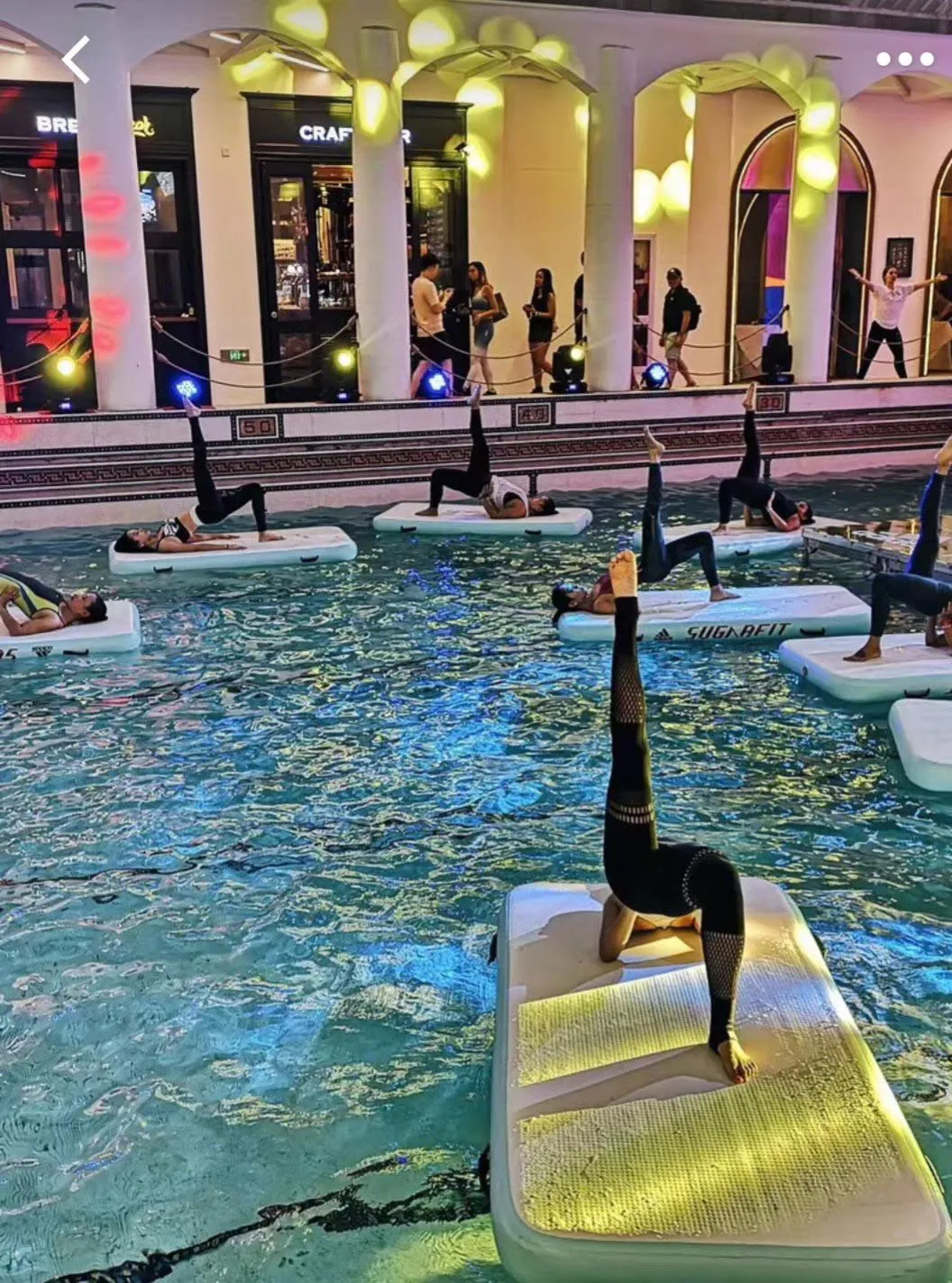 Hotel pool yoga mat floating on water